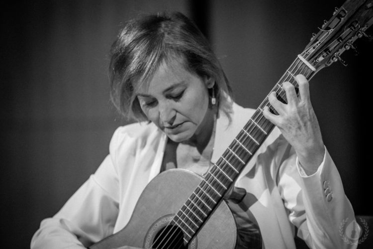 A guitarist concentrating on a musical phrase