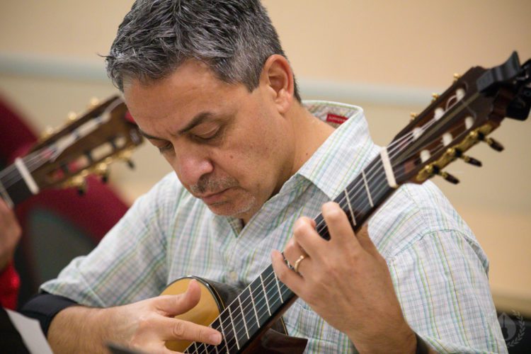 A guitarist working on a passage during CGC Summer School
