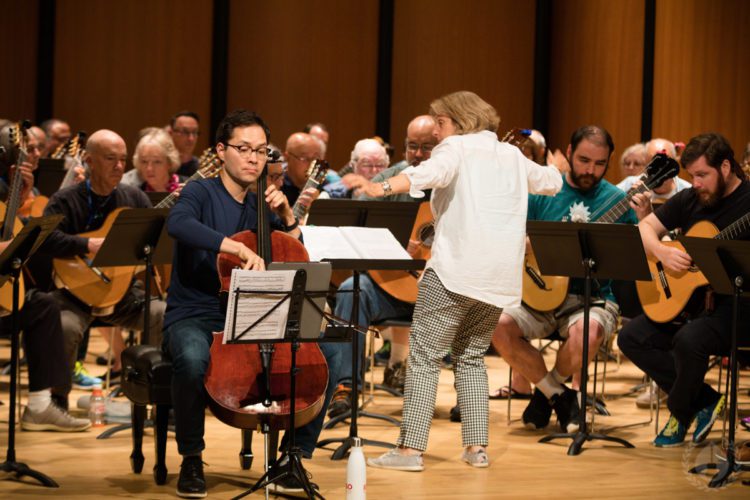Guitarists rehearsing together with a conductor at CGC Summer School