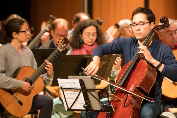 Guitarists reading from scores during an ensemble rehearsal