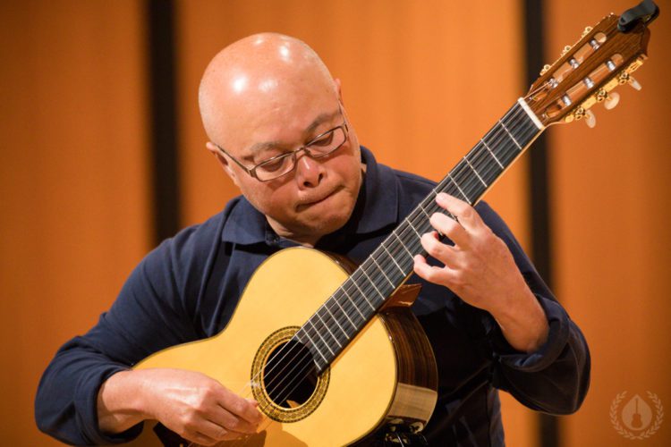 A guitarist concentrating on his playing at CGC Summer School